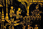 Wat Xieng Thong temple in Luang Prabang, Laos. Detail of the  intricate gold stencilling on black lacquer that decorate the walls of the sim. 